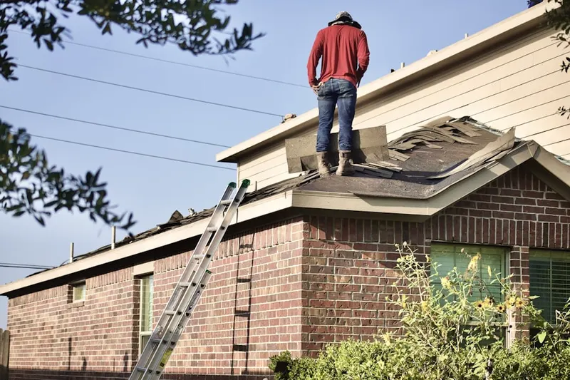 Professional roofer working on a residential roof in Virginia Lake